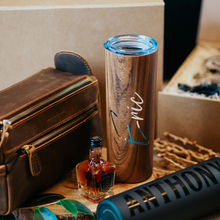 Load image into Gallery viewer, 20 oz personalized stainless steel skinny tumblers for men, with lid and custom name. Perfect groomsmen cups for the wedding day. Image displays a groomsman proposal box with its collection of gift items.
