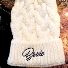 Load image into Gallery viewer, Soft ivory beanie with &#39;Babe&#39; in black embroidery and faux fur pom-pom. Perfect for a winter bachelorette party. 
