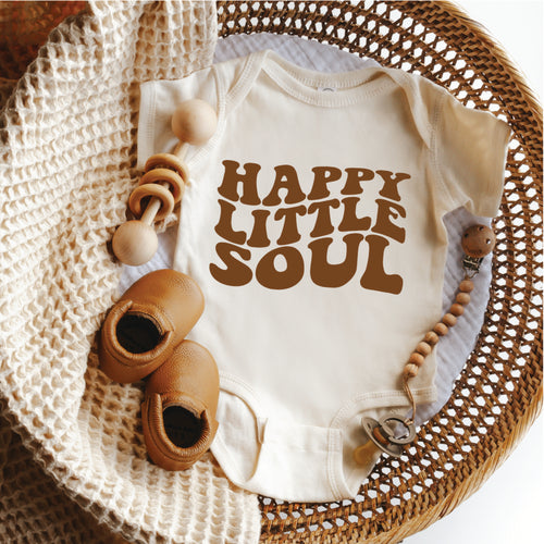 Image of Happy Little Soul Short Sleeve Baby Bodysuit made with organic cotton, featuring a boho-inspired design in neutral colors. The onesie is available in sizes 3-6 months and 6-9 months and is perfect for warmer weather or layering. The image shows the front of the onesie with short sleeves and snaps at the bottom for easy changing.