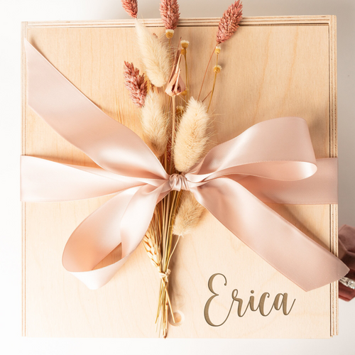 This engraved wooden keepsake box is the perfect gift for weddings, bridesmaid proposals, and brides-to-be. It comes with a satin ribbon in your color choice and an optional dried floral add-on for an extra touch of elegance. With ample space inside and a natural finish, this 10x10x5 inch personalized box is ideal for storing cherished memories and treasured keepsakes