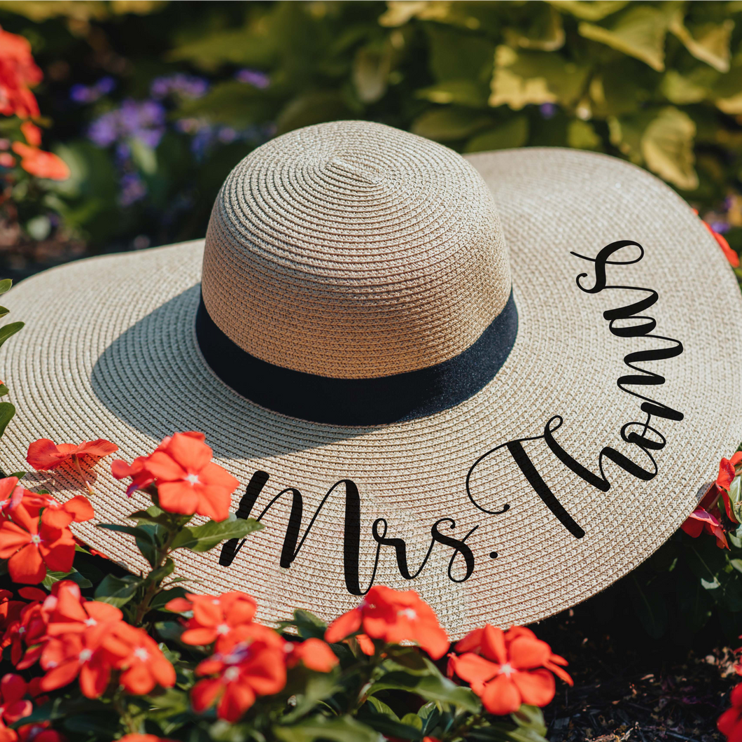 Stylish wide brim floppy hat, made with high-quality straw for maximum sun protection and personalized with a Mrs. [Last Name]