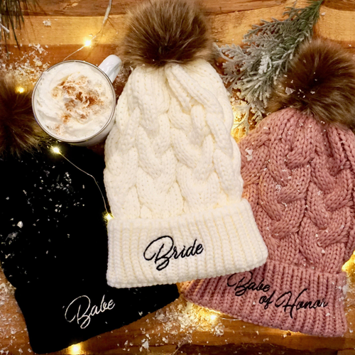 Bachelorette beanies with Bride, Babe, or Babe of Honor embroidery and faux fur pom-pom. Comes in black, ivory, or mauve, perfect for a winter ski trip.